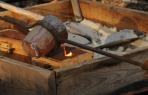 Pouring bronze into sand molds