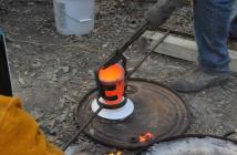 Bronze crucible being transferred to pouring shank
