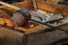 Pouring bronze into sand molds