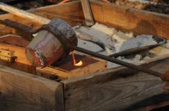 Pouring bronze into sand molds