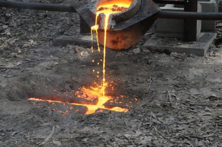 Pouring an Iron Cross in a mold carved in the ground.